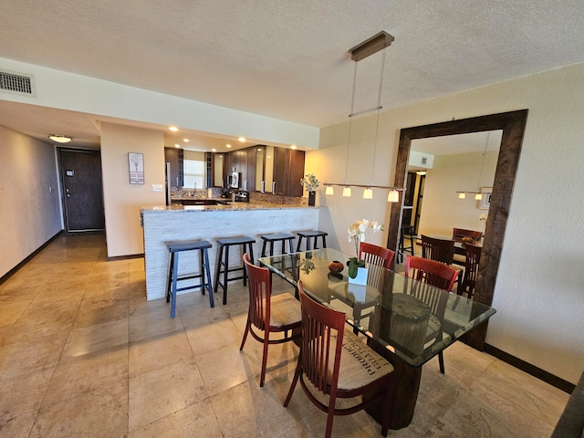 dining room featuring a textured ceiling