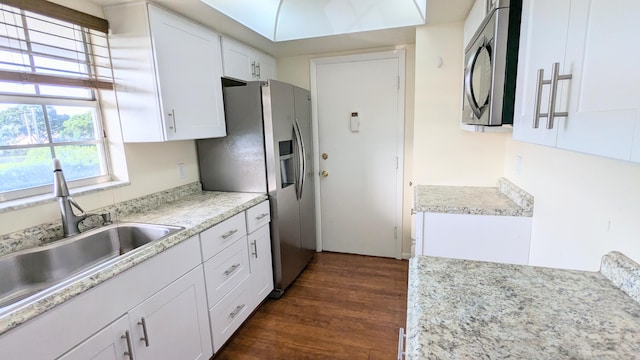 kitchen featuring sink, dark hardwood / wood-style flooring, white cabinetry, and stainless steel appliances