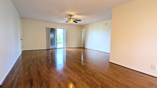 empty room featuring ceiling fan and dark wood-type flooring