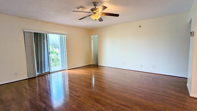 spare room featuring a textured ceiling, dark hardwood / wood-style floors, and ceiling fan