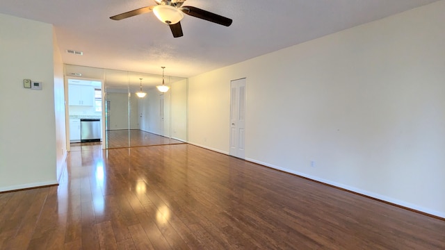 spare room with ceiling fan and wood-type flooring