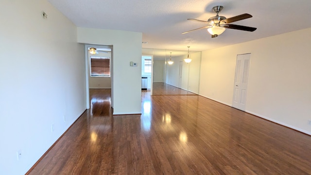 unfurnished room with dark hardwood / wood-style flooring and a textured ceiling