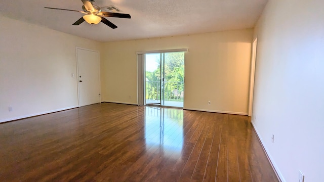 unfurnished room with ceiling fan, dark hardwood / wood-style flooring, and a textured ceiling