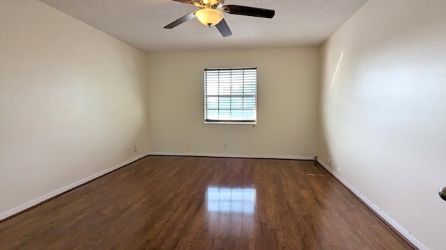 unfurnished room with a textured ceiling, ceiling fan, and dark wood-type flooring