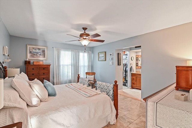 tiled bedroom with connected bathroom and ceiling fan