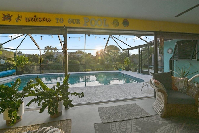 view of pool with a lanai and a patio area