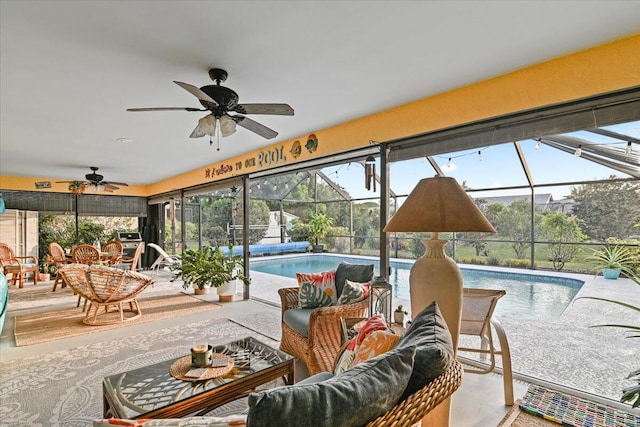 sunroom / solarium featuring ceiling fan, a healthy amount of sunlight, and a swimming pool