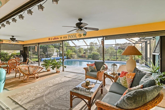 sunroom with a pool and ceiling fan