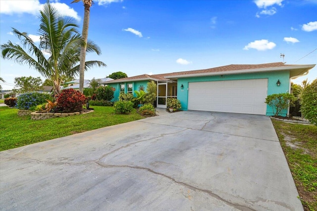 ranch-style house featuring a garage and a front lawn