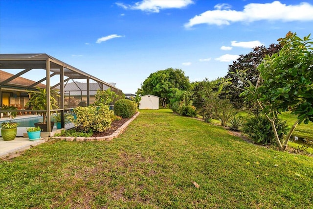 view of yard with a lanai and a shed