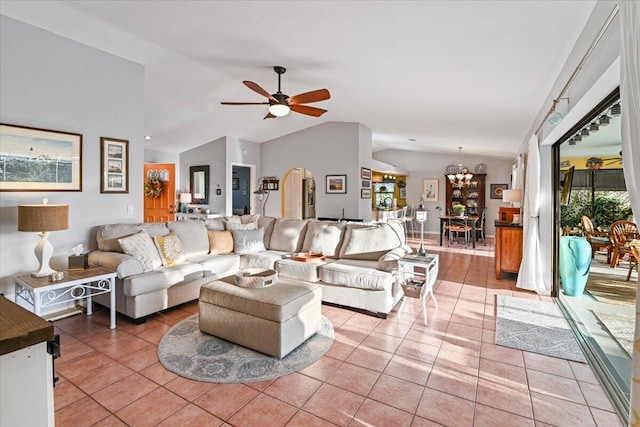 tiled living room featuring ceiling fan with notable chandelier and lofted ceiling