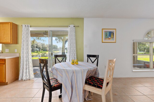 2538 12th Sq SW, Vero Beach, FL 32968 - tiled dining room with a water view, ceiling fan, and a healthy amount of sunlight
