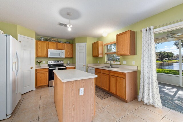 2538 12th Sq SW, Vero Beach, FL 32968 - dining area with a water view, plenty of natural light, and light tile patterned floors