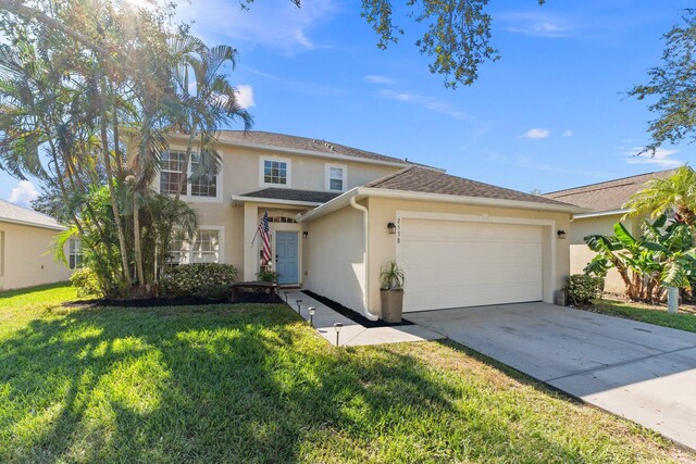 2538 12th Sq SW, Vero Beach, FL 32968 - view of front of home featuring a garage and a front lawn