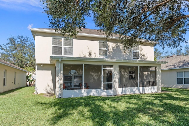 2538 12th Sq SW, Vero Beach, FL 32968 - rear view of house with a lawn and a sunroom