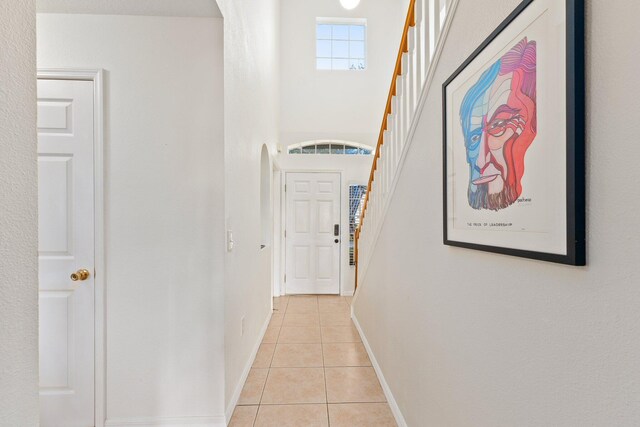 2538 12th Sq SW, Vero Beach, FL 32968 - stairs featuring tile patterned flooring, a notable chandelier, and a towering ceiling