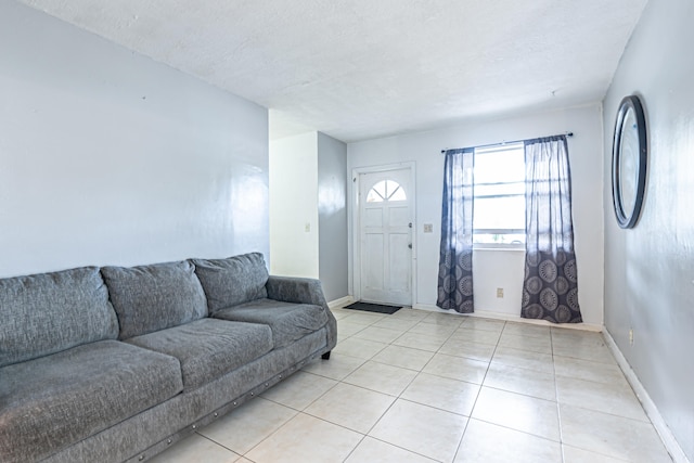 tiled living room featuring a textured ceiling