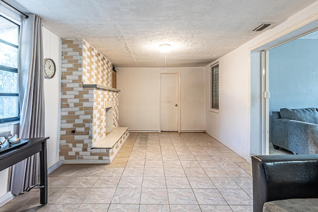 tiled foyer with a textured ceiling