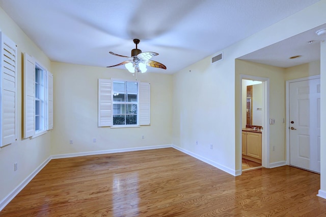 empty room featuring ceiling fan and light wood-type flooring