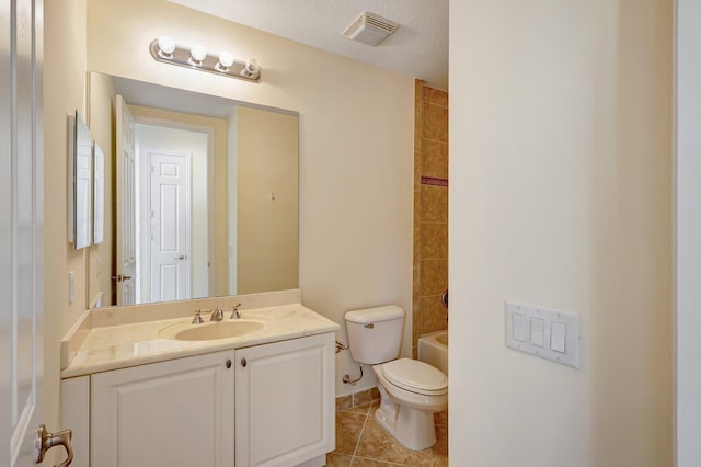 full bathroom featuring washtub / shower combination, vanity, a textured ceiling, tile patterned flooring, and toilet