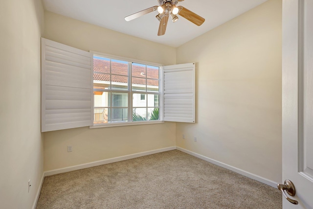 carpeted spare room with ceiling fan