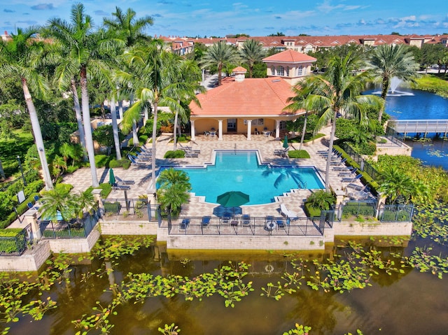 view of pool with a patio area and a water view