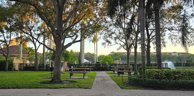 view of community with a yard and a water view