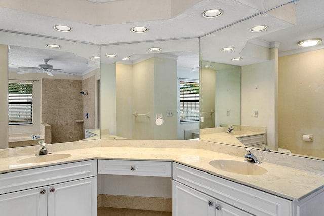 bathroom featuring a tile shower, vanity, ceiling fan, and ornamental molding