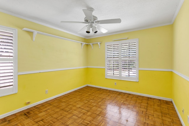 empty room featuring crown molding, light parquet flooring, a textured ceiling, and ceiling fan