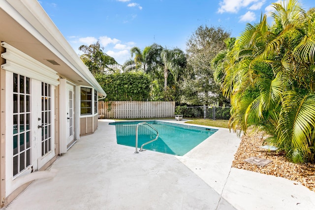 view of swimming pool with a patio area and french doors