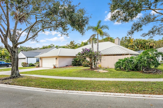 view of front facade featuring a front yard and a garage