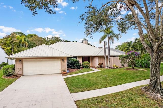 ranch-style house featuring a garage and a front yard