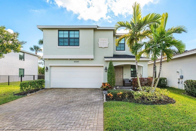 view of front of house featuring a garage and a front lawn