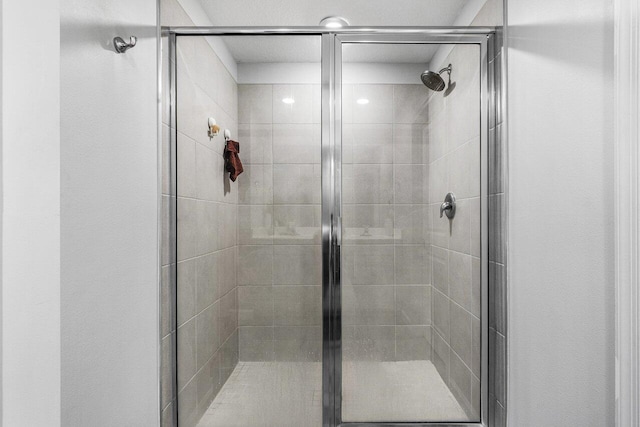 bathroom with a shower with shower door