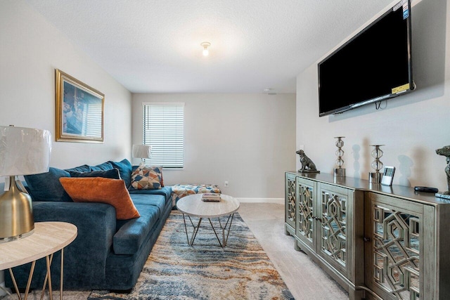 living room with a textured ceiling and light colored carpet