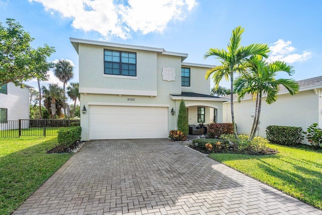 view of front of property with a garage and a front lawn