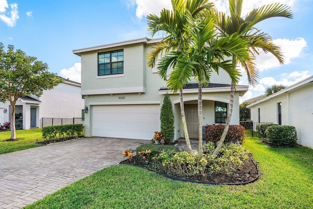 view of front of property with a front yard and a garage