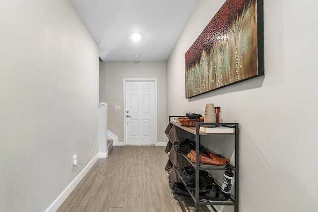 corridor with light hardwood / wood-style floors