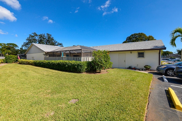 view of side of property featuring a lawn and stucco siding