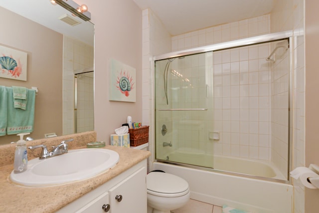 full bathroom featuring tile patterned floors, visible vents, toilet, shower / bath combination with glass door, and vanity