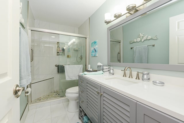 full bathroom featuring vanity, tile patterned floors, toilet, and a stall shower