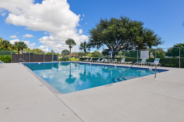 pool featuring a patio and fence