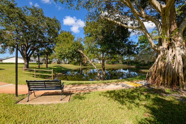 surrounding community featuring a yard and a water view