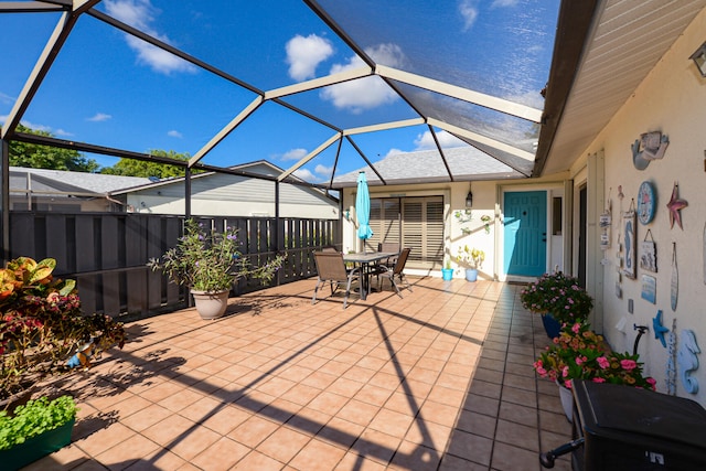 view of patio / terrace with a lanai and outdoor dining area