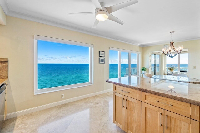 kitchen with pendant lighting, a water view, plenty of natural light, and ornamental molding