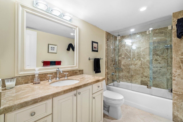 full bathroom with shower / bath combination with glass door, vanity, and toilet