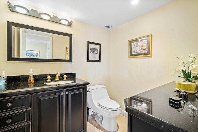 bathroom featuring vanity and toilet