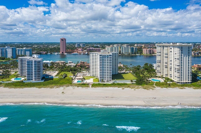 drone / aerial view featuring a water view and a view of the beach