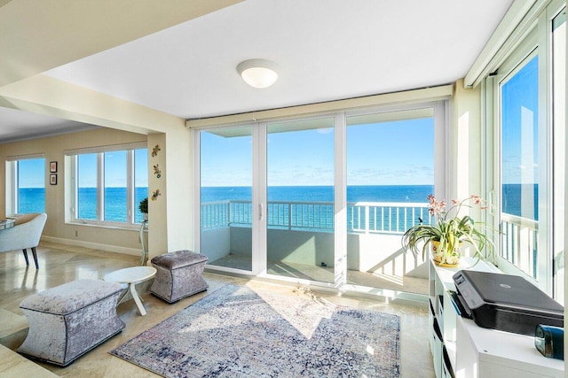 sunroom / solarium with a water view