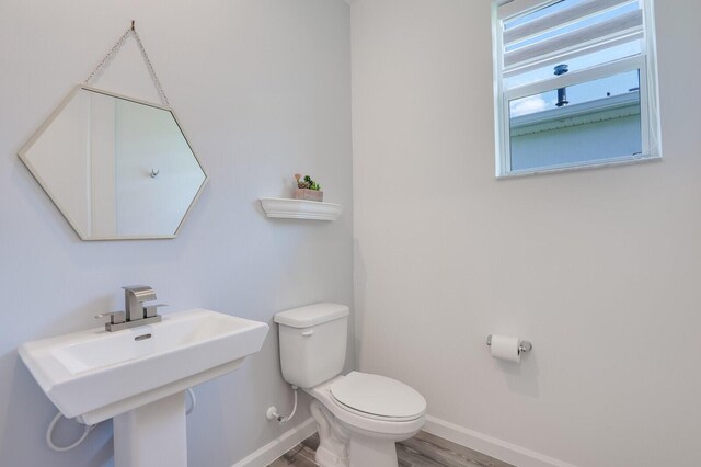 full bathroom featuring vanity, wood-type flooring, shower / tub combo, and toilet